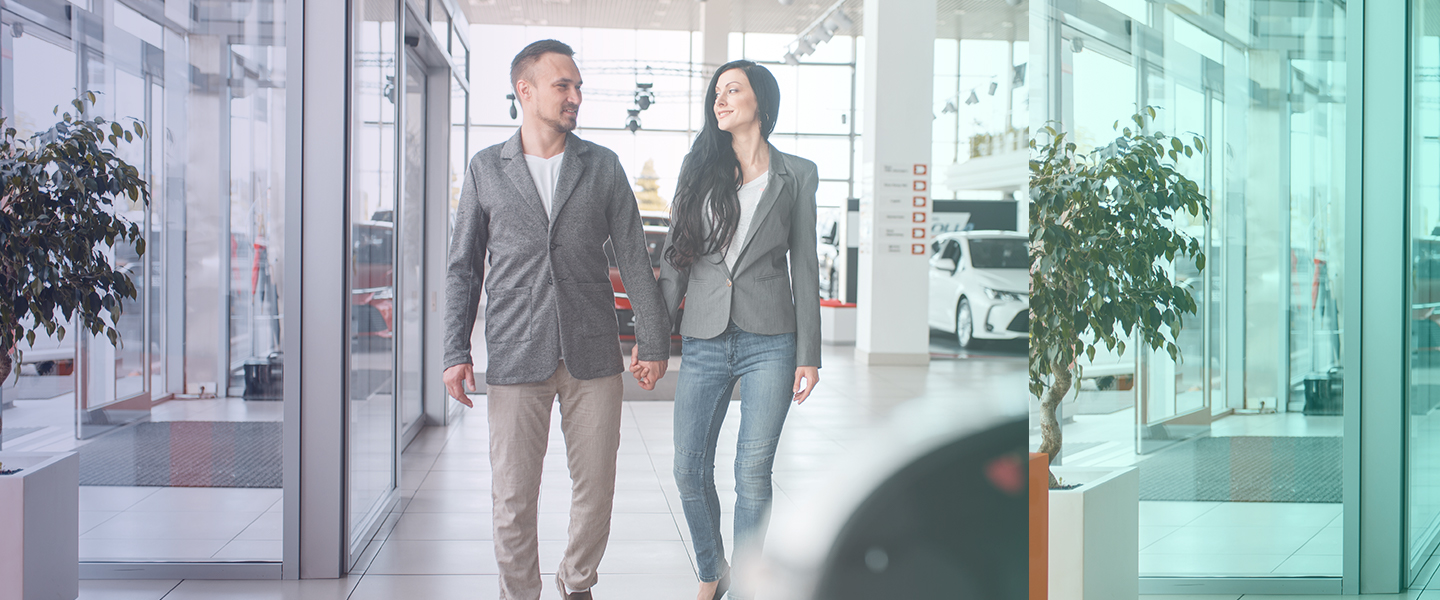 Car buyers having a good customer experience browsing a car showroom