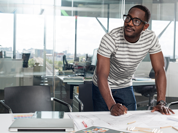 A global pharma leader - an African American man standing at a desk