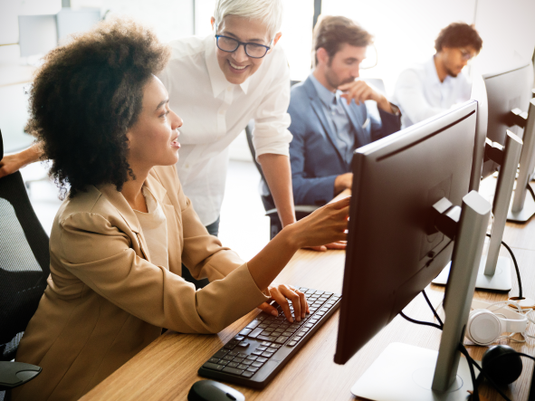 A global pharma leader - two people discussing work on a monitor