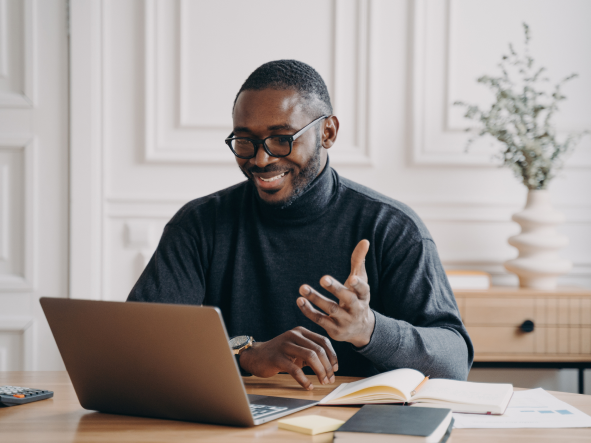 A global pharma leader - an African American man on a virtual call