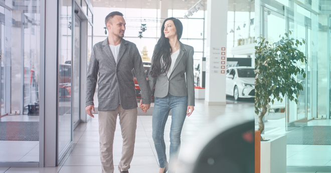 Car buyers having a good customer experience browsing a car showroom